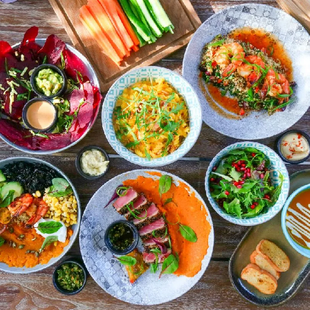 Bright pink interior of Bounty Beets café in Dubai Marina with healthy vegan brunch platter on the table