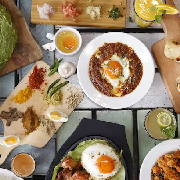 Close-up of spicy egg curry with buttery paratha served at Raju Omlet café in Dubai