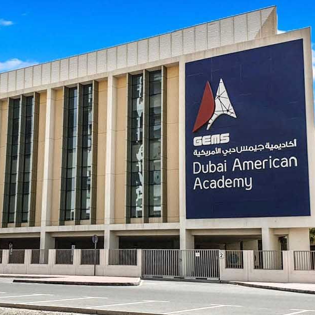 Dubai American Academy students using technology in a modern classroom with US and IB curriculum elements
