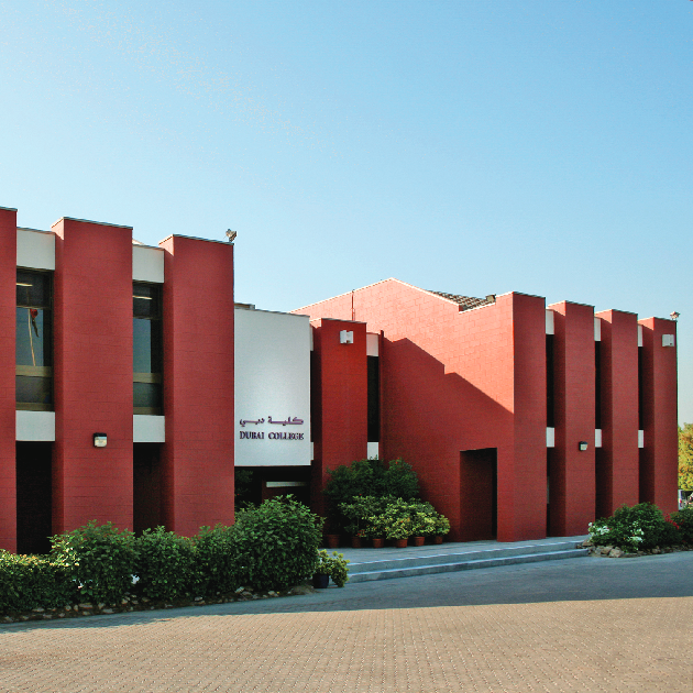 Dubai College campus building with students in British school uniforms walking outdoors