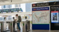 Expat woman using Nol card at Dubai Metro station in 2025