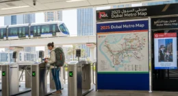 Expat woman using Nol card at Dubai Metro station in 2025