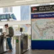 Expat woman using Nol card at Dubai Metro station in 2025