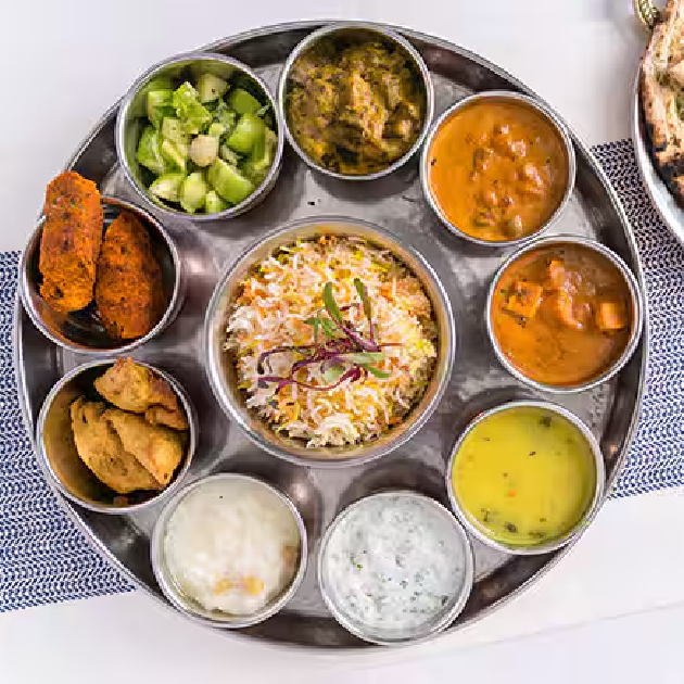 Colorful vegetarian Indian thali served at My Govindas in Dubai with curries, rice, and bread